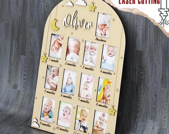 May include: A wooden baby milestone photo frame with the name "Oliver" at the top. It has spaces for photos from newborn to 12 months. The frame includes decorative stars, clouds, and the text "DIGITAL FILE FOR LASER CUTTING".