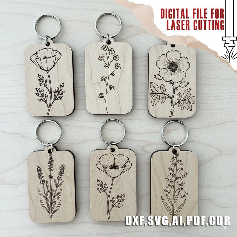 Puede incluir: Seis llaveros de madera con dise&ntilde;os florales grabados, incluyendo amapolas y lavanda. Cada llavero tiene un anillo plateado. El texto "DIGITAL FILE FOR LASER CUTTING" y abreviaturas de tipos de archivo son visibles.