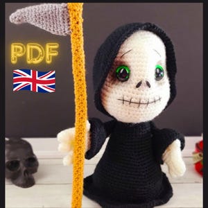 May include: Crochet pattern PDF for a Grim Reaper amigurumi doll. The doll is wearing a black robe and has a white skull face with green eyes. The doll is holding a yellow scythe.