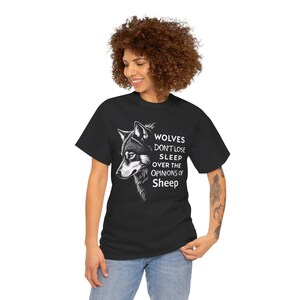 May include: Black t-shirt with a white wolf graphic and the text "WOLVES DON'T LOSE SLEEP OVER THE OPINIONS OF SHEEP".