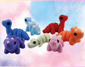 May include: A set of seven colorful dinosaur-shaped toys. The dinosaurs are made of a soft, pliable material and are perfect for imaginative play. The dinosaurs are blue, purple, green, orange, pink, and red.