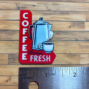 May include: Red and white sign with the words "Coffee Always Fresh" and a cartoon image of a coffee pot and a cup of coffee.