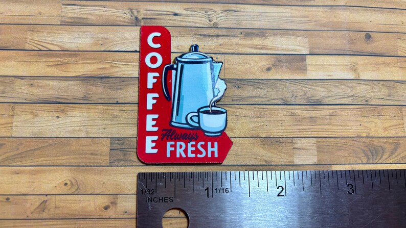 May include: Red and white sign with the words "Coffee Always Fresh" and a cartoon image of a coffee pot and a cup of coffee.