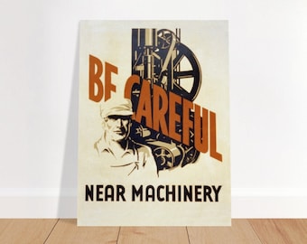 May include: Vintage safety poster with a worker in front of machinery. The poster is white with black and orange text that reads "Be Careful Near Machinery".