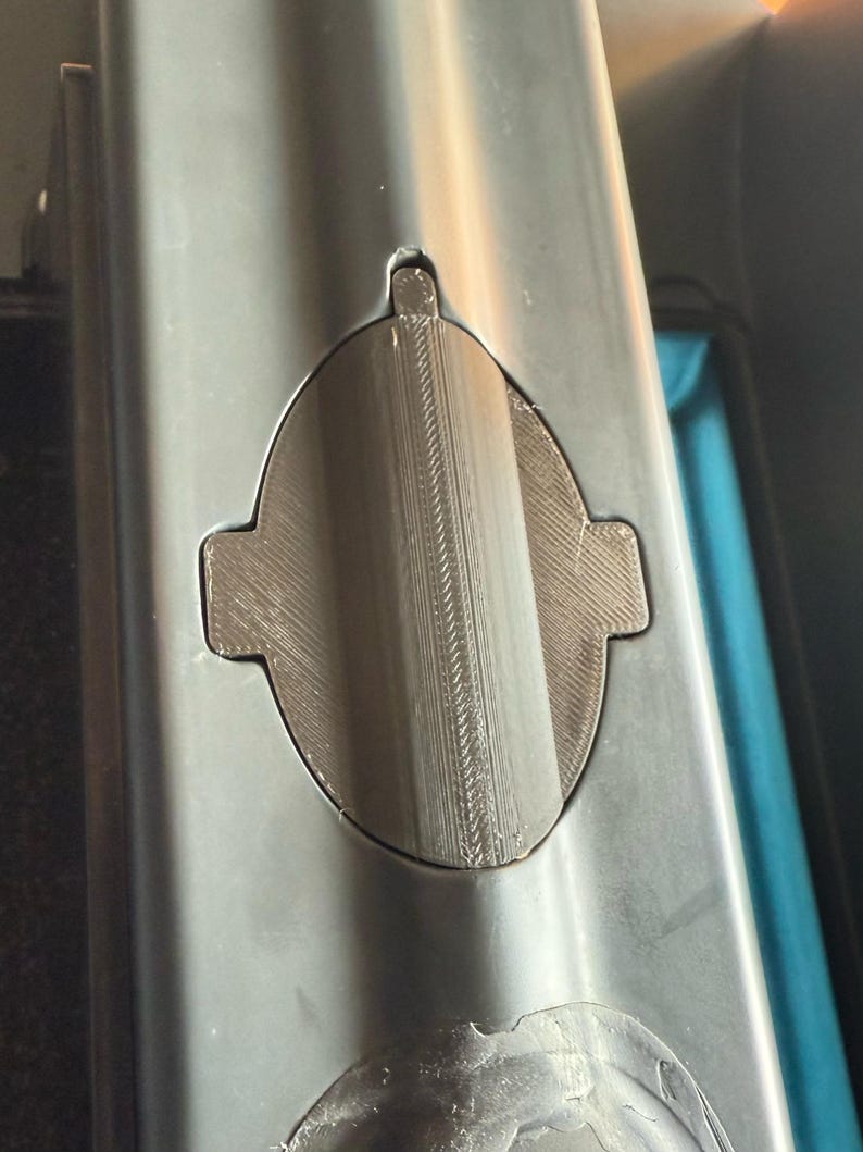 Sonar cover with side tabs fitted in the hull cutout, straight view from above