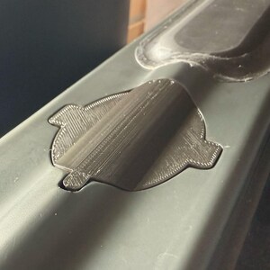 Sonar cover seen from the side, following the curved shape of the bait boat hull