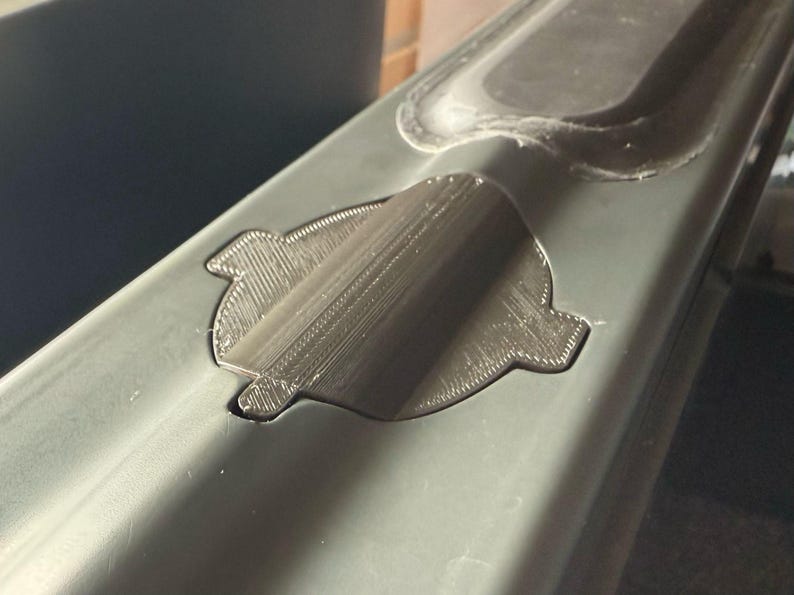 Sonar cover seen from the side, following the curved shape of the bait boat hull