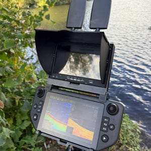 Winchcam monitor with sun visor clicked into the holder on top of the Carplounge AIO controller, sonar on the controller screen, antennas free