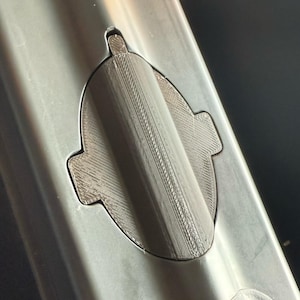 Black 3D printed sonar cover fitted flush in the sonar cutout of a Carplounge RT7 bait boat hull, top view