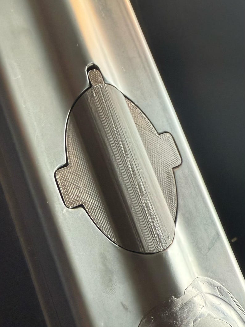 Black 3D printed sonar cover fitted flush in the sonar cutout of a Carplounge RT7 bait boat hull, top view