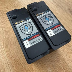 Two Carplounge RT4 RT7 smart batteries with the replacement levers folded down flat