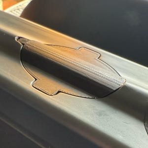 Close-up of the sonar cover sealing the unused sonar opening in the hull of a Carplounge bait boat
