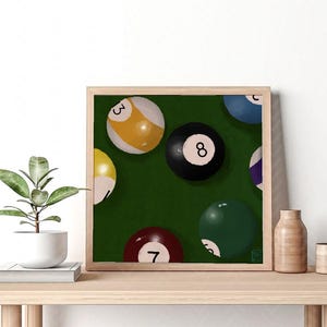 May include: A framed illustration of a green felt pool table with eight billiard balls, including a black ball with the number 8, a yellow ball with the number 3, and a green ball with the number 7.