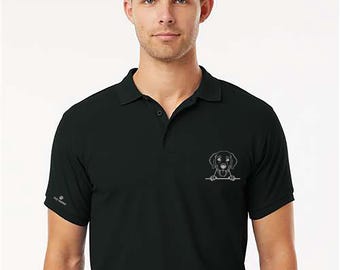 May include: Black polo shirt with a white outline of a dog peeking over a line on the chest. The shirt has a collar, short sleeves, and a small logo on the left sleeve. The shirt is made of a soft, breathable fabric.