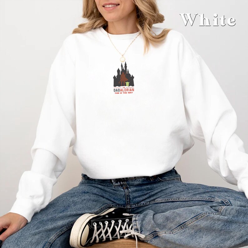 May include: White sweatshirt with a graphic of a castle and the text "DADALDRIAN" and "THIS IS THE WAY".