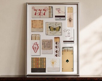 May include: A framed wall art print featuring a collection of various matchbox designs. The illustrations include the number 777, a butterfly, a strawberry, a cowboy boot, a spade symbol, musical notes, and abstract geometric patterns in red, black, and tan.