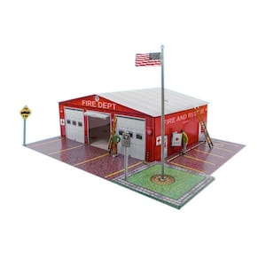May include: A red and white fire station building with the words "FIRE DEPT" and "FIRE AND RESCUE" on the front. The building has two garage doors and a flagpole with an American flag.