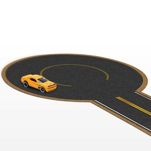 May include: A yellow toy car driving on a black and brown circular race track with a yellow line.