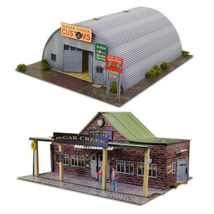 May include: Two model buildings, one a corrugated metal garage with "Sugar Creek Customs" sign and the other a brick building with a green roof and "Sugar Creek Trains" sign.