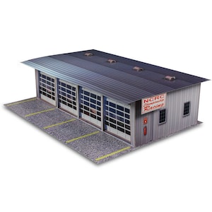 May include: A gray model building with a sign that reads "NCRC Championship Racing". The building has four garage doors and a small window. The building is sitting on a gray surface with yellow lines.