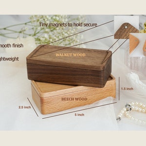 May include: Two wooden boxes, one walnut and one beech, with magnetic closures. The walnut box is 5 inches long, 2.5 inches wide, and 1.5 inches high. The beech box is 5 inches long, 2.5 inches wide, and 1.5 inches high.
