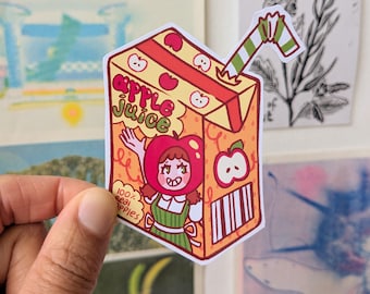 May include: A colorful sticker featuring a cartoon apple juice box with a smiling character in an apple costume. The box is yellow and orange with red apple accents and the words "Apple Juice". A green and white striped straw is attached.