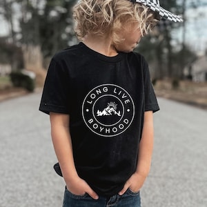 May include: Black t-shirt with a white circle graphic that says "Long Live Boyhood" with a mountain and sun design inside the circle.