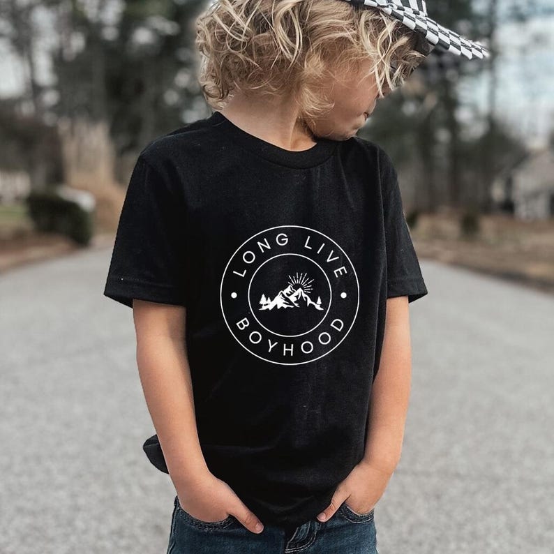 May include: Black t-shirt with a white circle graphic that says "Long Live Boyhood" with a mountain and sun design inside the circle.