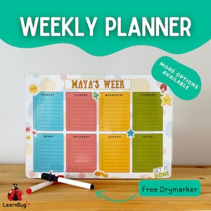 May include: A weekly planner with sections for each day, featuring the text "WEEKLY PLANNER". The planner includes a free dry-erase marker. The planner is designed with colorful sections for each day of the week.
