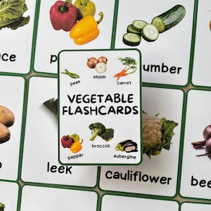 May include: Educational vegetable flashcards with illustrations of vegetables like peppers, broccoli, and aubergine. The cards have a white background with green borders and the text "Vegetable Flashcards".