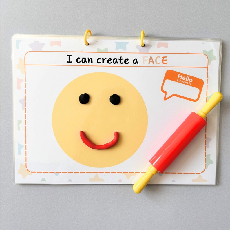May include: A children's activity set with the text "I can create a FACE". The set includes a yellow smiley face with black eyes and a red smile made of clay. A red and yellow rolling pin is also included.