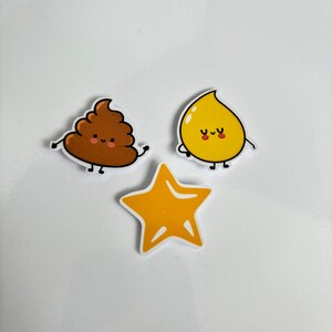 May include: Three cartoon stickers with happy faces. A brown poop sticker, a yellow teardrop sticker, and a yellow star sticker.