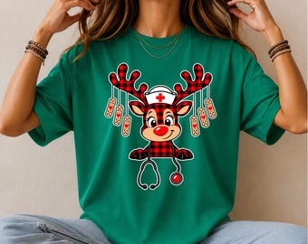 May include: A Kelly Green t-shirt featuring a graphic of a reindeer wearing a nurse cap and a stethoscope. The reindeer has red and black buffalo plaid antlers and body, with several adhesive bandages hanging from the antlers.