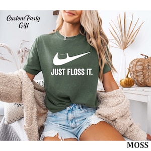 a woman in a green shirt that says just floss it