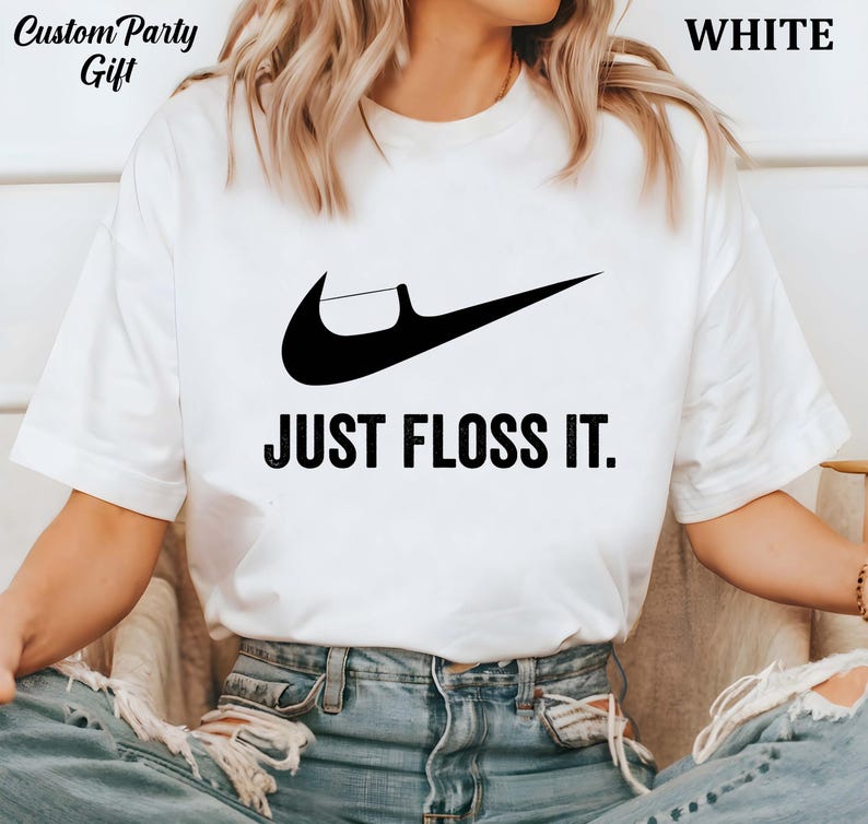 a woman wearing a t - shirt that says just floss it