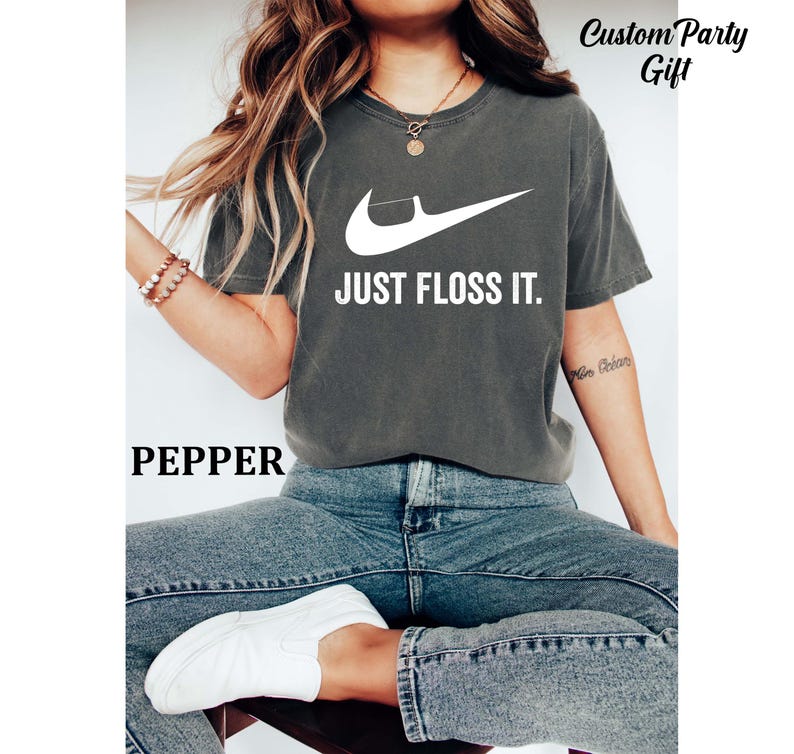 a woman sitting on a stool wearing a nike t - shirt