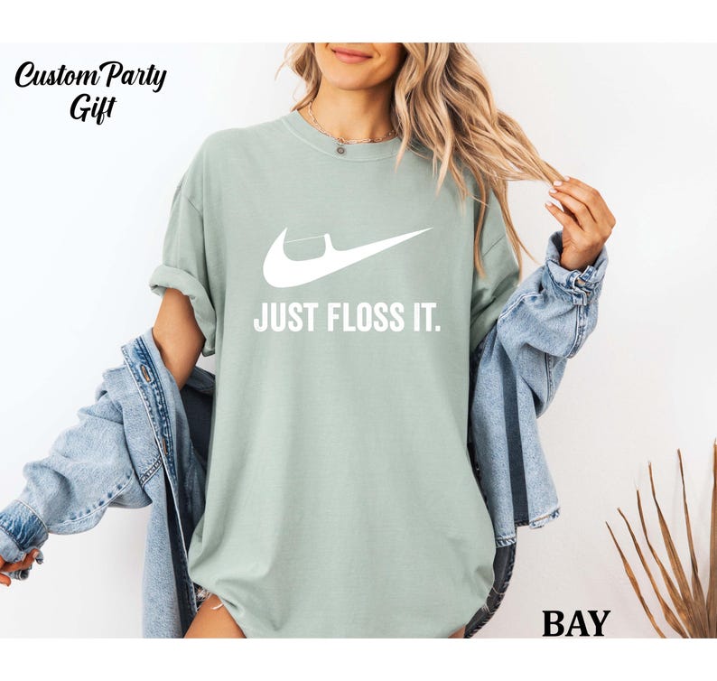 a woman wearing a t - shirt that says just floss it