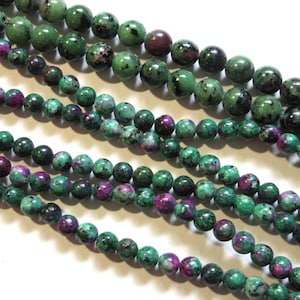 May include: Multiple strands of round, polished gemstone beads featuring a mottled pattern of deep forest green and vibrant magenta-pink. The beads vary in size across the different strands, showcasing natural mineral inclusions and dark speckles.