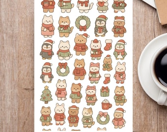 May include: A sticker sheet featuring various cartoon animals in festive attire. The stickers include cats, bears, penguins, and bunnies wearing scarves, hats, and holding gifts. The sheet has a white background with the words "STICKER SHEET" at the bottom.