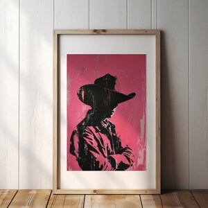 May include: A black silhouette of a person wearing a cowboy hat and a jacket, standing against a pink background.