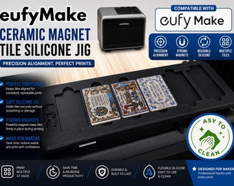 May include: A black silicone jig for eufyMake ceramic magnet tiles, featuring multiple rectangular slots for precision alignment. The device includes strong magnets to hold tiles securely during printing, with text labels highlighting features like reusable silicone and easy cleaning.