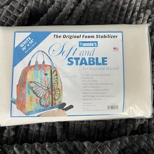 May include: White foam stabilizer sheet, 36 inches by 58 inches, by Annie's Soft and Stable. The packaging shows a bag with a butterfly design and the text "For Bags and Beyond!"