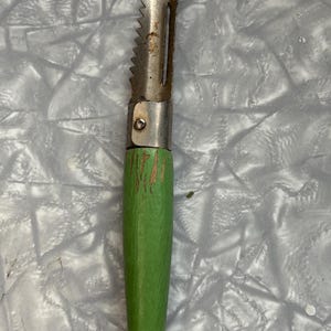 Vintage wooden handled vegetable peeler