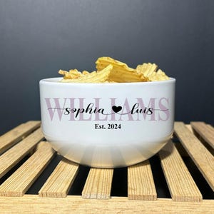 May include: A white ceramic bowl filled with ridged potato chips. The bowl features the text "WILLIAMS" in large light purple letters, with "sophia" and "luis" in black script separated by a heart, and "Est. 2024" printed in black below.