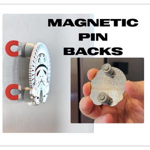 May include: Magnetic pin backs with a silver Stormtrooper design. The text "MAGNETIC PIN BACKS" is displayed in black block letters. The pin is attached to a silver surface with red and silver magnets.