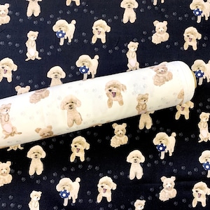 May include: A white fabric with a repeating pattern of brown poodle dogs playing with a ball. The fabric is rolled up and the pattern is visible on both the front and back of the fabric.