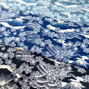 May include: Three pieces of fabric with a Japanese-inspired design featuring white cherry blossoms, blue waves, and a mountain range on a dark blue background.