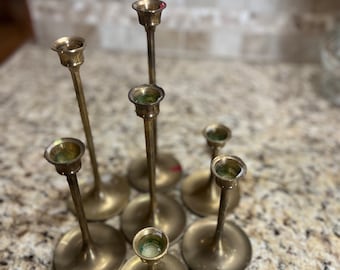 set of various size brass candle stick holders, vintage mid century