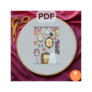 May include: A cross-stitch pattern featuring a ghost, pumpkins, and other Halloween-themed imagery. The pattern is displayed on a white embroidery hoop with a wooden frame. The text "PDF" is displayed in a black box above the hoop.