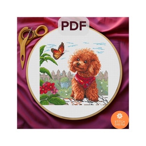May include: Cross stitch pattern featuring a brown poodle with a red bandana sitting in a garden setting with a butterfly and flowers. The pattern is in a round embroidery hoop.